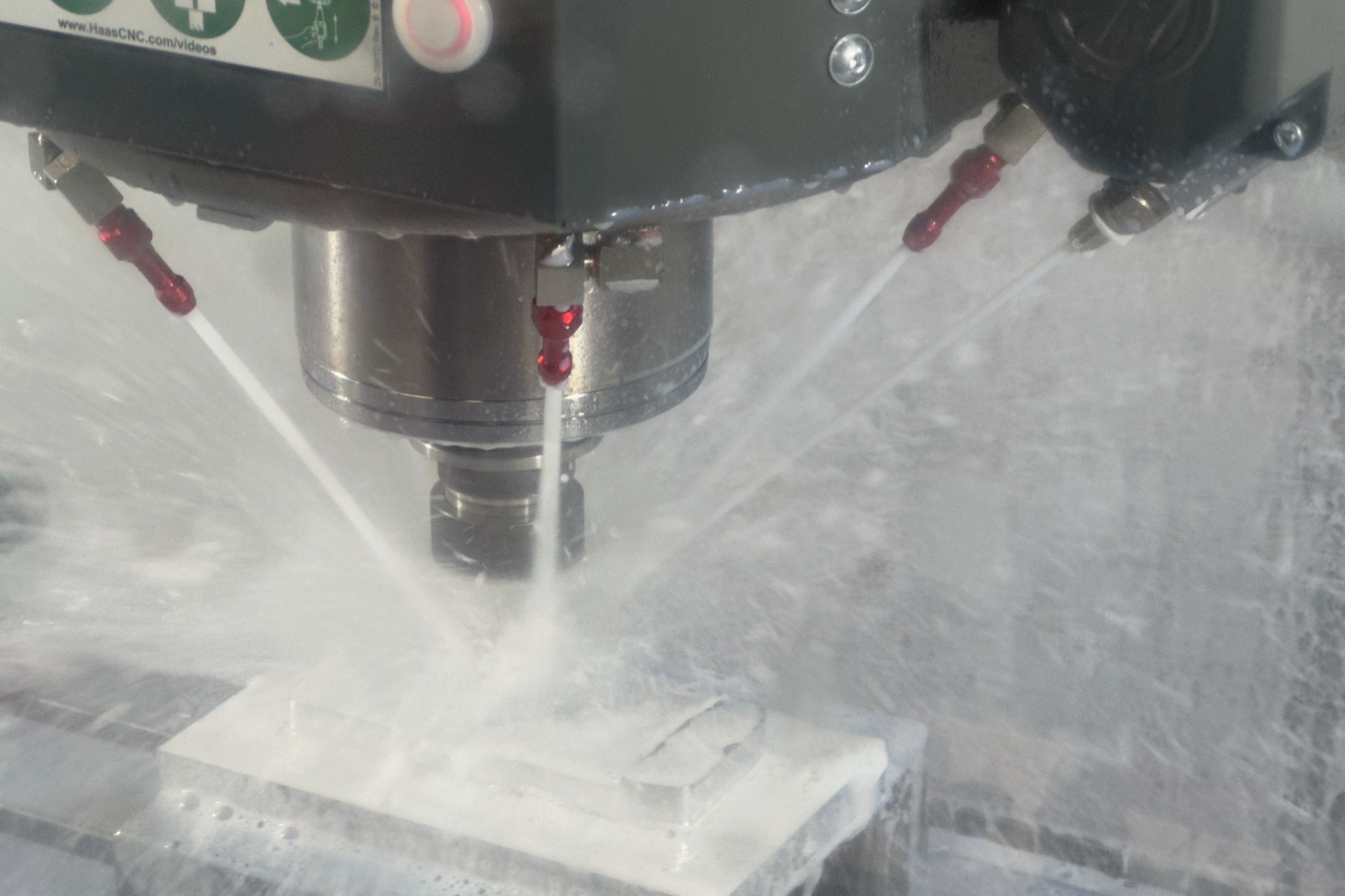 A vertical machining center cutting an aluminum part